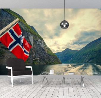Picture of Mountain landscape with cloudy sky Majestic Geiranger fjord  View from ship Norvegian flag against beautiful nature of Norway